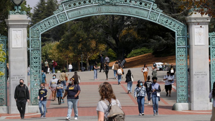 FILE: Students walk near the Sather Gate on the UC Berkeley campus in Berkeley, Calif., on Tuesday, August 24, 2021.