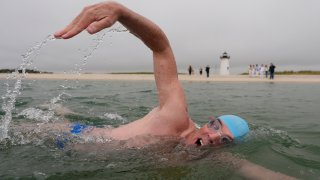 Endurance swimmer Lewis Pugh swims near the Edgartown Harbor Light, Thursday, May 15, 2025, in Edgartown, Mass.