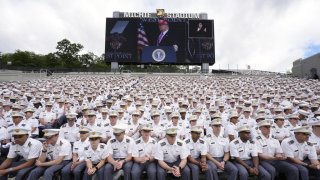 Cadets listen as President Donald Trump, seen on screen, speaks to United States Military Academy graduating cadets during commencement ceremonies in West Point, N.Y., Saturday, May 24, 2025. (AP Photo/Manuel Balce Ceneta)